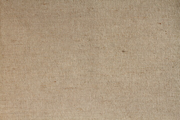 Background - beige rough tarpaulin cloth. Horizontal photo. Closeup. Macro