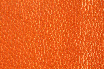 Orange colored cow leather texture. Closeup. Macro