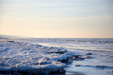 Winter view on the icy sea coast and beautiful calm sky, selective focus