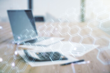 Abstract virtual wireless technology hologram with hexagon on calculator and laptop background. Big...
