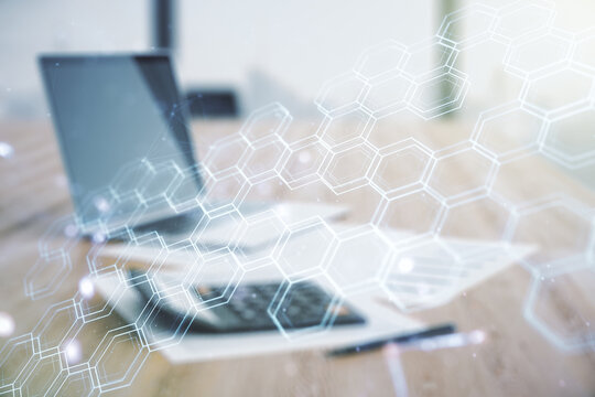Abstract virtual wireless technology hologram with hexagon on calculator and laptop background. Big data and database concept. Multiexposure