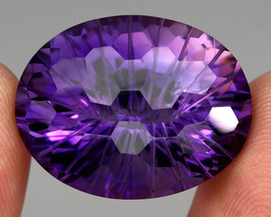 Natural stone purple amethyst on a gray background