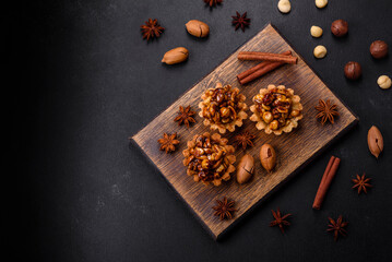 Sweet tasty tart with nuts and honey on a dark concrete background
