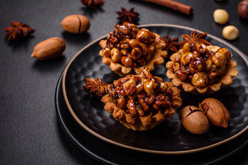 Sweet tasty tart with nuts and honey on a dark concrete background