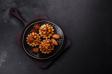Sweet tasty tart with nuts and honey on a dark concrete background