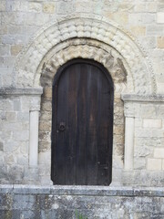 Fototapeta na wymiar Wooden arched doors on the façade