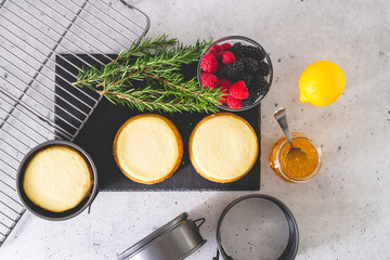 Mini cheesecakes, and ingredients for the dessert topping close-up, flat lay