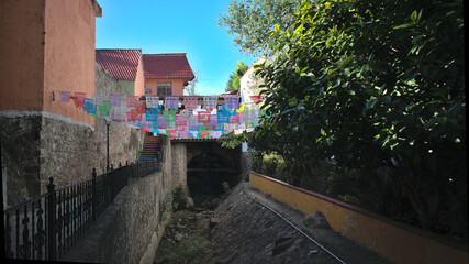 Street decorated with confetti where a river passes