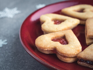 Homemamde linzer Christmas cookies filled with red strawberry marmalade