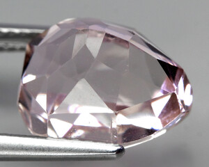 Natural beautiful gemstone kunzite on gray background