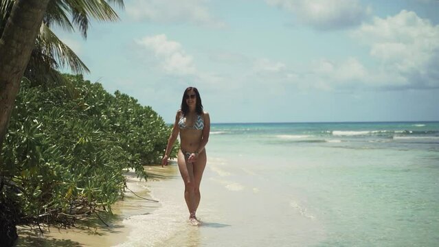 Young beautiful European female fit tanned model having fun at exotic paradise Saona island in Dominican Republic	

