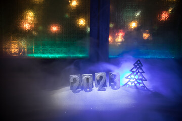 Happy New Year 2023. A frame of kitchen utensils, Christmas decorations, cinnamon, food and spruce branches on a marble background. A greeting card for Christmas. The concept of cafes and restaurants.