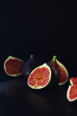 Ripe juicy figs in low key