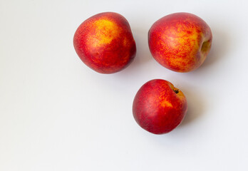 Three ripe nectarine fruits isolated on white background copy space. Healthy food