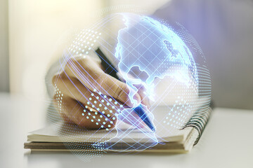 Double exposure of digital America map and man hand writing in notebook on background, research and strategy concept