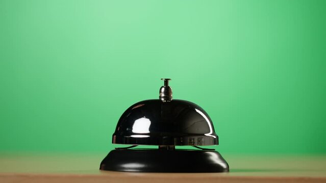 Person Guest Hand Ringing Service Restaurant or Hotel Bell Hold By Waiter, Phone with Chroma Key Green Screen for Application. Smartphone App for Service.