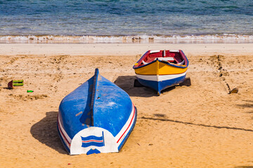 Two boats in the Atlantic sandy beach of Tarrafal, Santiago Island, Cape Verde Islands
