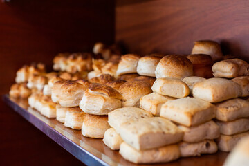 Bakery shop with bread on wooden shelf. Bakery goods