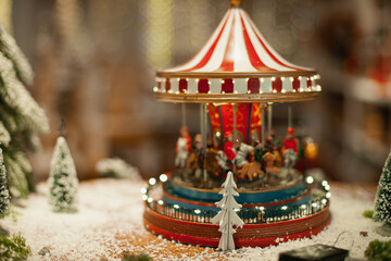 Vintage carousel home decoration for winter holiday season on sale at Christmas market. Festive xmas background wallpaper.