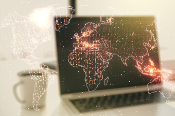 Multi exposure of abstract creative digital world map on modern laptop background, tourism and traveling concept concept