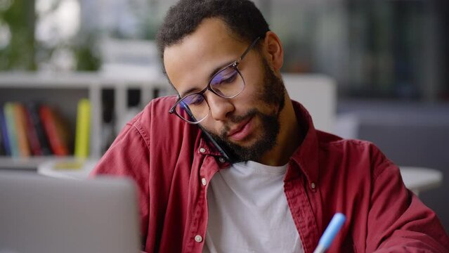 Close up African American business coach, prosperous teacher talking on phone during online class