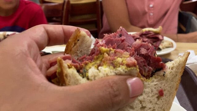 woman eating delicious pastrami sandwich closeup image healthy food