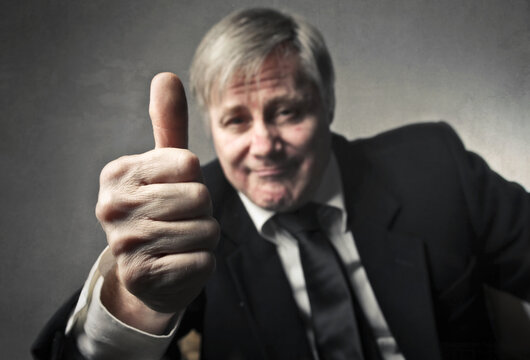 portrait of adult man with thumbs up