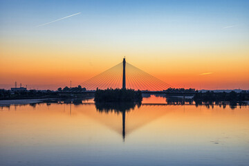 Bridge Over The Guadiana River At Sunset. Bridge reflected in the river.