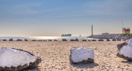 boat in the sea horizon, stone on the beach.