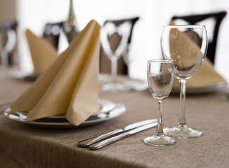 empty goblets and other cutlery are served on the festive table.