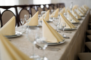 empty goblets and other cutlery are served on the festive table.