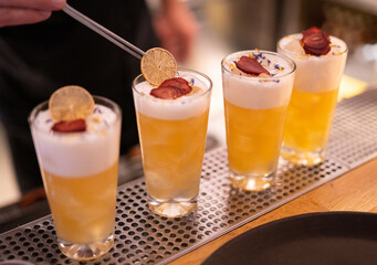 beautiful and delicious alcoholic cocktails prepared at the bar by the bartender.