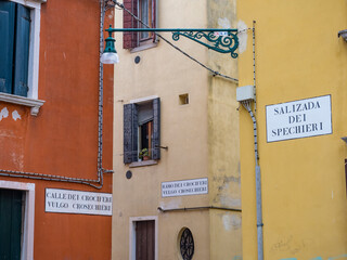 Fototapeta premium Typical alleyway of Venice with the names of the roads on the wall