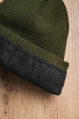 Dark green cap on a wooden board. Cap for military men
