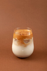 Glass of Dalgona Misugaru Latte. Korean refreshing drink made from roasted multi grain powder, milk...