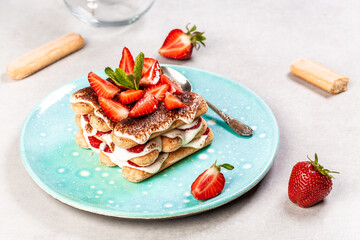 Strawberry tiramisu with mascarpone. Summer dessert, classic tiramisu with strawberries decorated with mint leaves