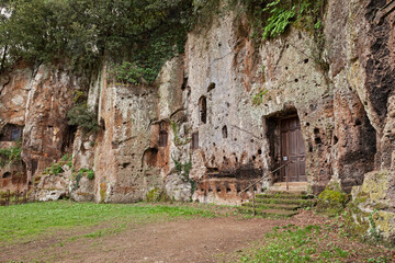 Sutri, Viterbo, Lazio, Italy: facade of the Mitreo, ancient rock-cut church of the Madonna del Parto, developed out of a mithraeum, pagan cult site, in Etruscan archaeological site - 556544288
