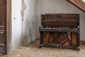 Destroyed piano in an abandoned old historic mansion palace in Poland in Central Europe