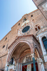 Fototapeta na wymiar The façade of Lodi Cathedral dedicated to the Virgin of the Assumption built in the 12th century in Romanesque style with belfry and rose window, Lodi city, Lombardy region, Italy