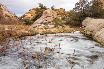 Large boulders and a frozen pond in Joshua Tree National park, California