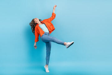 Fototapeta na wymiar Full length photo of young attractive woman energetic crazy dance summer vacation wear trendy orange look isolated on blue color background