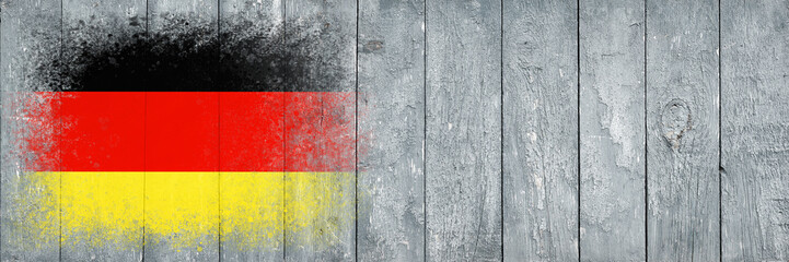Flag of Germany. Flag is painted on a gray wooden plank surface. Wooden background. Plywood surface. Copy space. Textured background