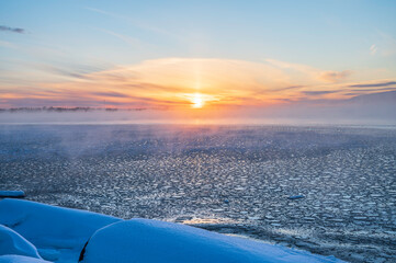 View of the frozen sea and setting sun. Pörkenäs, Finland.