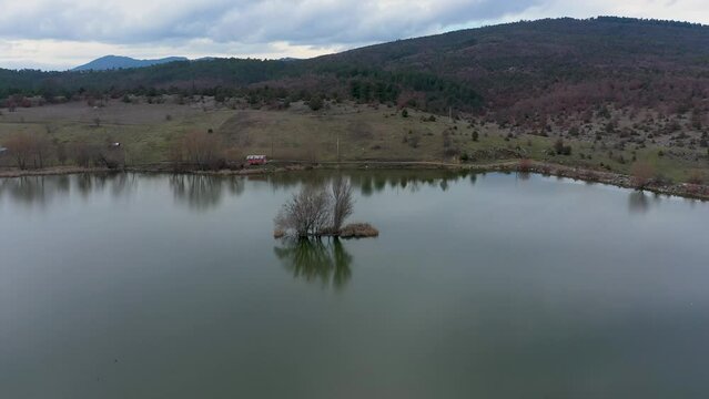 Footage of snowy  peaks with reflection of mountain and sky on lake water, gokoz national park near to bursa city and beautiful view angle of uludag mountain