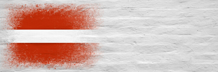 Flag of Latvia. Flag painted on a white plastered brick wall. Brick background. Copy space. Textured background