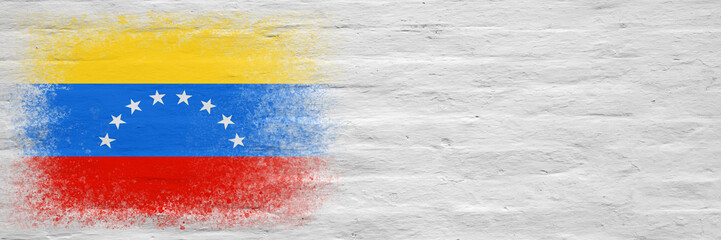 Flag of Venezuela. Flag painted on a white plastered brick wall. Brick background. Copy space. Textured background