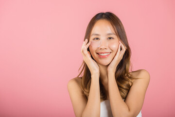 Femininity. Asian beautiful young woman smiling mask cosmetic patches gel under the eyes, Portrait female touching clean skin medical hydrogel eye patch on face, isolated on pink background, skincare