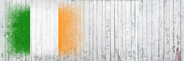 Flag of Ireland. Flag is painted on a white wooden surface. Wooden background. Plywood surface. Copy space. Textured background