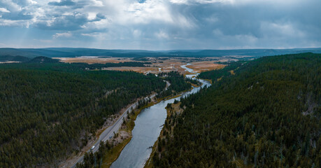 Fototapeta na wymiar Yellowstone National Park aerial panoramic view. Endless forests and river going through the valley.