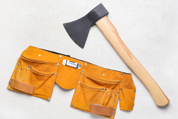 Ax and tools belt on white background